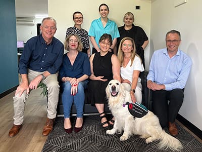 Quentin the dog from Integra Service Dogs visits BidWrite staff in Brisbane as part of a community impact initiative