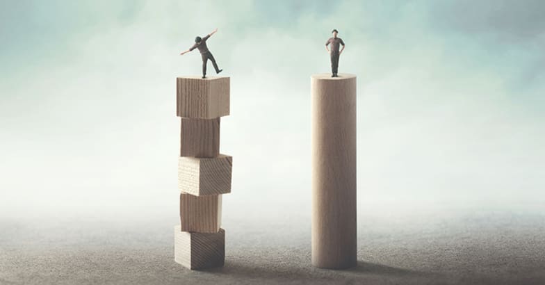 Men stand on two blocks representing different careers - straight and narrow lawyer or varied, dynamic Bid Consultant