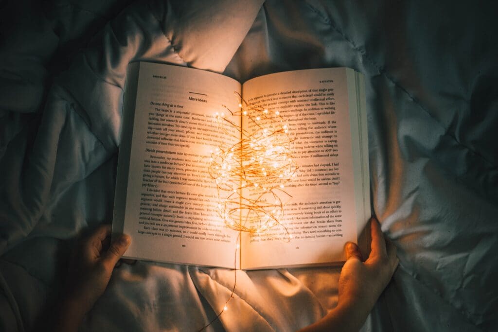 Lights illuminating pages of a book, representing compelling storytelling